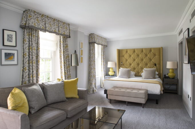 Hotel bedroom showing bed and sofa in foreground.