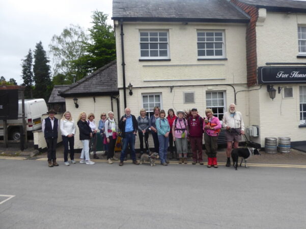 Group of walkers standing in front of a white building.
