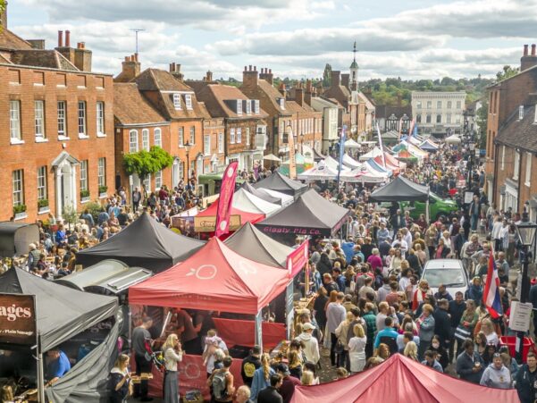 Picture of many food stalls and lots of people around them