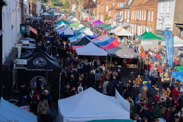 Aerial view of crowded street market and colourful marquees