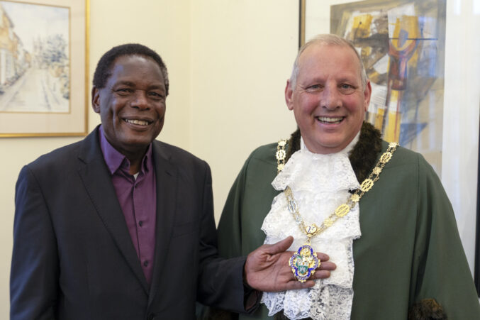 A man in a suit with the Mayor