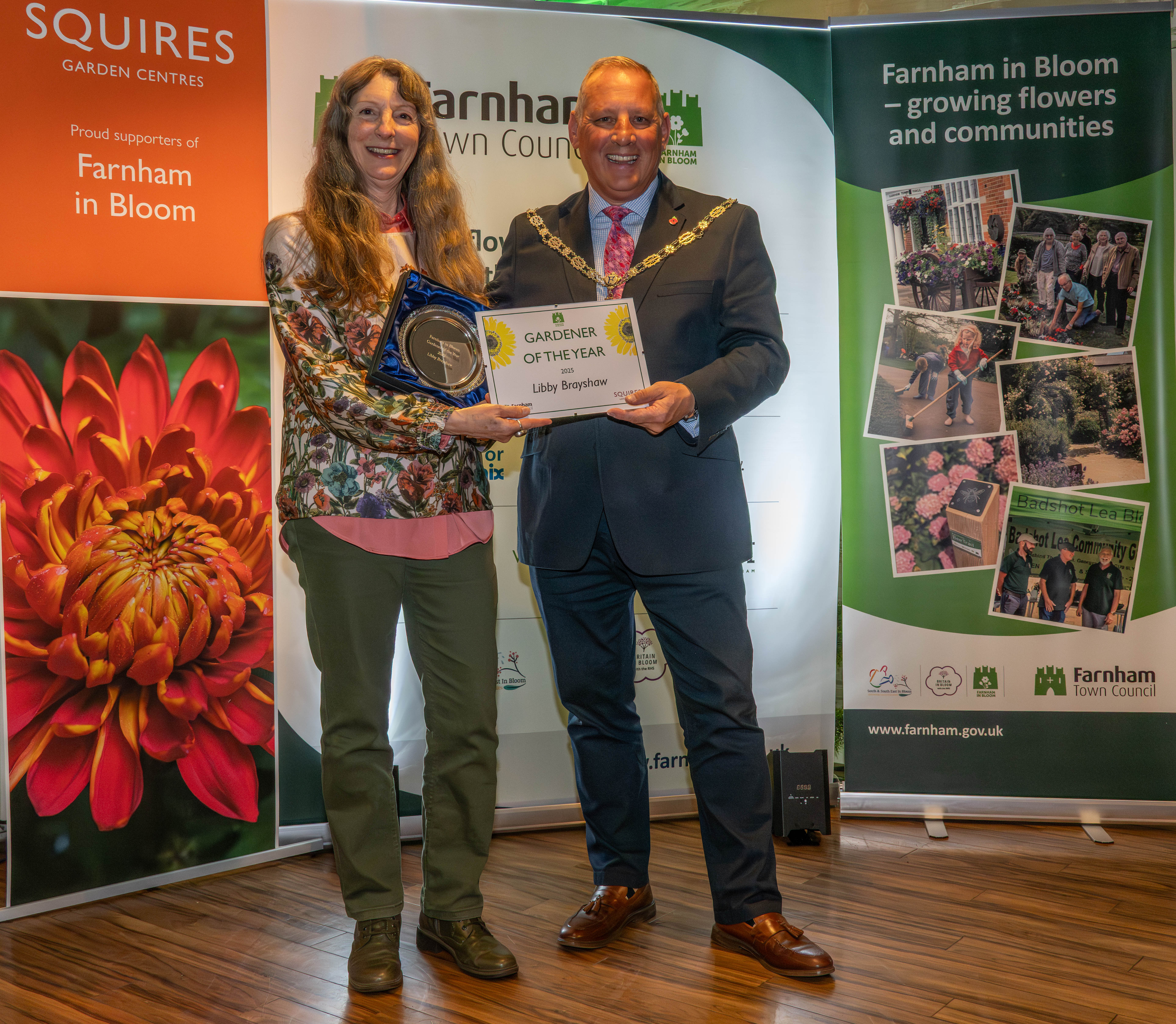 Mayor presents a Gardener of the year certificate to a female.